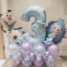 the balloon centerpiece is made to look like an ice queen and frozen prince number