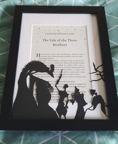 the shadow of two people in front of a book with an image of a dragon on it