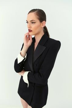 Black tie only. Nevro's flawless vision translates to this black wool tuxero jacket, tailored with hand-rolled shoulders and satin peak lapels. Adding some drama, while the jacket sleeve's length reach up to the wrist, the ending of the sleeves make a hold statement with an extention of white gabardine. Androgynous allure at its best. Black Double Breasted Long Sleeve Suit For Evening, Black Double Breasted Suit With Long Sleeves For Evening, Black Blazer With Structured Boning And Long Sleeves, Black Long Sleeve Blazer With Structured Boning, Luxury Black Blazer Dress For Semi-formal Occasions, Luxury Black Blazer Dress For Semi-formal Events, Luxury Long Sleeve Formal Pantsuit, Black Double-breasted Tuxedo For Office, Double-breasted Tuxedo Blazer With Pressed Crease