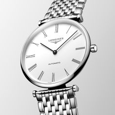 Launched in 1992, La Grande Classique de Longines has played a major role in forging the reputation of the winged hourglass brand. This range is a symbol of Longines’ classic elegance and timeless sophistication, and stands out thanks to its very slim profile and wide palette of versions. Timeless Jewelry And Watches With Polished Round Dial, Timeless Jewelry And Watches With Polished Finish, Classic White Watch With Metal Dial, Classic White Watches With Metal Dial, Timeless White Watches, Timeless Round Watches With Polished Finish, Timeless Watch With Subdials For Anniversary, Classic Timeless Design Watch For Gift, Formal White Gold Watch With Timeless Design