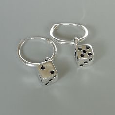 A PAIR of sterling silver hoops. Comes with a detachable dice charm. The charm is multipurpose and can be used with a neck or bracelet chain too. Dimension: Hoop- 12x1 mm Charm: 5 x8 mm Drop length- 19 mm These earrings are made of real 925 hypoallergenic sterling silver. Please let me know if you want the piece in a gift box. I can write out a message from you to the receiver if needed. Please be free to contact me at... bhavnakwintra1956@gmail.com More hoops: https://www.etsy.com/your/shops/Th Silver Sterling Silver Huggie Earrings For Gift, Silver Round Huggie Earrings Gift, Minimalist Charm Earrings For Gifts, Nickel-free Silver Dangle Huggie Earrings, Silver Nickel-free Dangle Huggie Earrings, Silver Dangle Huggie Earrings Nickel-free, Silver Huggie Earrings With Charms, Silver Charm Hoop Earrings, Nickel-free Sterling Silver Huggie Earrings As Gift