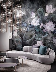 a living room filled with lots of furniture and flowers on the wall next to a chandelier