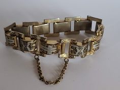 "Measures Approx. 7 1/2\" long x 5/8\" wide Previously Owned Condition. Does have wear to finish on the back of bracelet. NOTE: This style the safety clasp did not come apart, it is connected to the bracelet on both ends. See photos. My items are previously owned or vintage items. As with most previously owned items they may have light surface scratches or very light wear. PLEASE NOTE: Due to the exorbitant fees attached to selling online, any sale item purchased through Etsy Marketing program maybe canceled and refunded. If you are unfamiliar with Etsy Marketing please read Etsy's site.  Sorry for any inconvenience this may cause." Vintage Adjustable Chain Link Bracelet, Vintage Engraved Chain Link Bracelet, Vintage Engraved Chain Link Bracelets, Vintage Engraved Link Bracelets, Adjustable Chain Bracelet With Box Clasp, Adjustable Link Chain Bracelet With Clasp, Vintage Chain Link Metal Bracelets, Vintage Metal Bracelets With Chain Link, Adjustable Formal Chain Bracelet With Clasp