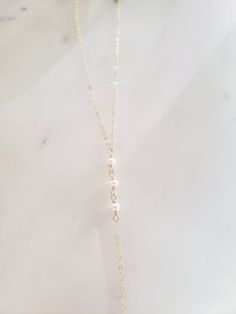 "These dainty and thoughtfully designed necklaces are stunning paired as a set or on their own! Would be wonderful for a bride or as a feminine and lovely touch to your every day. Genuine freshwater pearls are wire wrapped in a minimal/vintage-y/boho style. Made from top quality materials- true 14k gold fill or solid sterling silver, will not tarnish or turn you green, wear 24/7! Secured with an easy to use oval lobster clasp. Lead and nickel free. Excellent for sensitive skin! Come packaged in Delicate 14k Gold Filled Lariat Jewelry, Pearl White Pearl Chain Necklace For Wedding, Elegant Pearl White Chain Necklace For Wedding, Delicate Pearl Lariat Necklace With Pendant, Pearl Chain Necklace With Pearl Charm For Wedding, Pearl Chain Necklace With Pearl Pendant For Wedding, Elegant Layered Necklace With Pearl Charm For Gift, Elegant Layered Pearl Drop Necklace As Gift, Elegant White Layered Necklace With Adjustable Chain