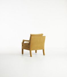 a yellow chair sitting on top of a white floor