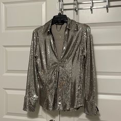 Zara, Beautiful, Silver Sequin Top, Pointed Collar, Relatively Low, V-Neck, Long Sleeves. Hook, And I Closure In The Front Cuffs Do Not Have Button Closure Never Worn, Marked As A Small But Fits Like A Medium.Smoke-Free Pet Free Home Shoulders Left Or Right 14 “ Length Top To Bottom 21 “ Sleeves 23” Really Pretty, And Fashionable, Not Fully Lined Fitted Long Sleeve Shimmer Blouse, Fitted Shiny Tops For Evening, Fitted Shiny Evening Tops, Elegant Shiny Tops For Night Out, Elegant Fitted Metallic Tops, Elegant Fitted Shiny Top, Metallic Long Sleeve Glamorous Blouse, Metallic Fitted Tops For Formal Occasions, Fitted Metallic Tops For Formal Occasions