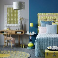 a bedroom with blue, yellow and green decor on the walls is pictured in this image