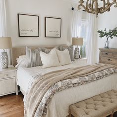 a bedroom with a large bed and two pictures on the wall