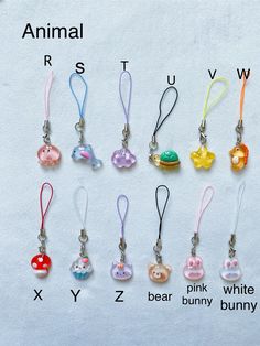 an animal keychain with various charms attached to it's sides, all in different colors