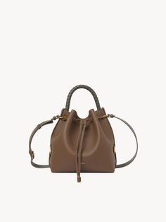 Chloé Marcie Bucket Bag | Chloé US Textured Calf Leather Bucket Bag, Pebbled Leather Bucket Bag With Detachable Strap, Pebbled Leather Bucket Bag, Soft Calf Leather Bucket Bag, Calf Leather Bucket Bag For Travel, Pebbled Leather Bucket Bag With Removable Pouch, Pebbled Leather Everyday Bucket Bag, Pebbled Leather Bucket Bag With Textured Detail, Everyday Pebbled Leather Bucket Bag