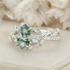 Step into whimsical charm with our Nature Inspired Twist Leaf Hexagon Cut Moss Agate and Diamond Engagement Ring, crafted in exquisite 14K White Gold. This enchanting piece captures the essence of nature's beauty, adding a touch of whimsy to your love story. Whimsical Rings, Whimsical Ring, Nature Inspired Rings, Moss Agate, Nature Beauty, Diamond Engagement Ring, Nature Inspired, Diamond Engagement, Diamond Engagement Rings