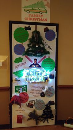 a christmas bulletin board in the corner of a room with lights on it and decorations