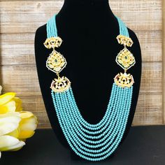 Turquoise Beads Necklace / Blue Beads Long Necklace/ Beaded Kundan Jadau Mala / Statement Necklace/ Blue Multi strand Beaded Mala Description: Made in Brass with Turquoise Blue beads Necklace Length: 11" Necklace comes with Golden Thread Dori Extension at the end for adjustable length Made with very high quality turquoise Blue beads Suitable for any festive/special occasion Comes with Designer Broch Pendants on both sides with Kundan, Meenakari and Pearl work. Blue Beaded Chain Jewelry For Wedding, Elegant Blue Turquoise Necklace With Colorful Beads, Elegant Turquoise Necklace With Large Blue Beads, Elegant Large Beads Turquoise Necklace, Traditional Blue Beaded Jewelry, Elegant Blue Turquoise Necklace With Large Beads, Traditional Blue Beaded Necklaces, Traditional Blue Faceted Beads, Blue Beaded Pearl Necklace With Round Beads