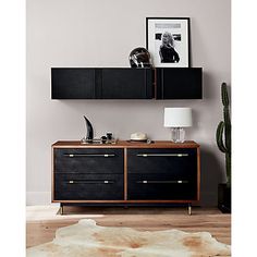 a living room with a black cabinet and white rug