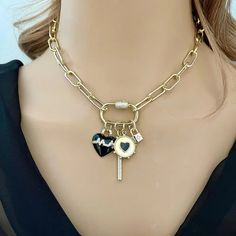 This necklace features a chunky open link paperclip chain with 14k gold plating. The chain is electroplated for durability. 4 gorgeous charms attached. The Charms hang on a gold plated carabiner CZ screw clasp and are removable. 1.Black and gold enamel beating Heart Charm. 2.Black and gold enamel Heart charm 3.Gold CZ padlock Charm 4.CZ Bar Charm Available in many lengths. Please choose length from drop down menu Tips to keep your jewelry looking good. 1) Keep jewelry away from water and chemica Beautiful Gold Necklaces, 18k Gold Necklace, Beating Heart, Unusual Jewelry, Gold Necklaces, Gold Choker, Necklace Online, Classic Gold, Gold Enamel