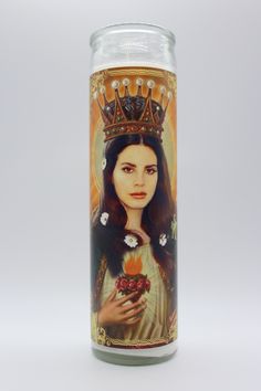 a candle with an image of a woman holding flowers and a crown on her head