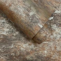 an old wood textured wallpaper with brown and white paint on the top half