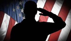 a man saluting in front of an american flag