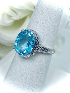 Classic Topaz Birthstone Jewelry, Fine Jewelry Topaz Birthstone Gemstones, Blue Topaz Ring In 14k White Gold, Luxury Blue Topaz Cushion Cut Ring, Fine Jewelry Gemstones With Diamond Cut, Classic Topaz Gemstones As A Gift, Formal Luxury Topaz Birthstone Ring, Classic Topaz Ring For Gifts, Classic Topaz Birthstone Ring With Center Stone