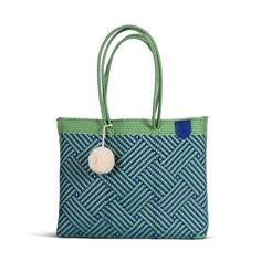 Meet your new favorite beach bag. This super flexible, water-resistant woven Super Tote is made using 100% recycled plastic to fit all your beach-day essentials with a spacious interior and comfortable handles for toting anywhere.  The Super Tote is the perfect size and style to carry everything you may need for a beach vacation including your towel, go-to book, sunnies, snacks, and as many sunscreens as you want.  Handmade with amor from ethically sourced high-quality materials, this bag will become your wardrobe favorite for every occasion from a picnic to a beach day to carrying your farmer's market finds.  Comes with a FREE Pompom while supplies last. Colors and sizes may vary and are not always the ones pictured. How am I made?  My journey begins in Oaxaca, where the artisans that mak Casual Blue Packable Beach Bag, Summer Reusable Bag For Vacation, Packable Blue Rectangular Shoulder Bag, Blue Woven Shoulder Bag With Double Handle, Green Double Handle Beach Bag For Vacation, Blue Woven Bag For Everyday Use, Blue Woven Bags For Everyday Use, Eco-friendly Blue Beach Bag For Beach Season, Blue Summer Packable Bag