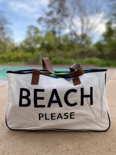 The perfect accompaniment to your trips to the shore, the lake or a weekend getaway - this "BEACH PLEASE" large canvas tote bag! It's perfect for carrying your seashells, beach reads, and other beach necessities. It's lightweight, durable, and stylish - you'll be prepared for any adventure! So grab your shades and your bag- BEACH PLEASE! Made of canvas and brown vegan leather 20" wide 11" tall 5" deep Large Capacity Cotton Bag For Beach Season, Casual White Beach Bag With Canvas Lining, White Everyday Beach Bag With Canvas Lining, White Beach Bag With Canvas Lining, Summer Vacation Canvas Bag With Canvas Lining, White Beach Bag With Canvas Lining For Everyday, Large Capacity Tote Canvas Bag For Beach, Large Capacity Beach Tote Canvas Bag, Large Capacity White Canvas Bag For Beach Season