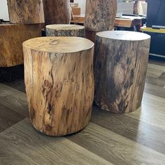 three wooden stools sitting on top of a hard wood floor