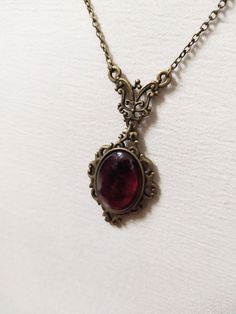 ◆ Victorian style necklace. The red blood cabochon size is 0.984252 x 0.708661 inches and it was completely handmade in resin. The inserts, the base and the chain are in bronze, The product is made by hand with great care. ♡ In my shop there are many handmade jewelry for all tastes, come and watch them are welcome! ♡ Red Amulet Necklace, Victorian Era Necklace, Antique Garnet Pendant Necklace, Victorian Ruby Necklace For Formal Occasions, Antique Engraved Red Jewelry, Red Gothic Necklace For Formal Occasions, Red Engraved Antique Jewelry, Oval Cabochon Brass Necklace, Victorian Copper Necklace As Gift