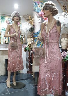 "Gorgeous 20's, 30's Downton Abbey style dress heavily embellished with golden bronze glass beads and sequins on a beautiful dusty pink net sheer. Luxurious and opulent this dress has an amazing Art Deco pattern front and back, a gathered flattering skirt lined with dusty pink polyester fabric. In very good condition.  Please, check the measurements below: Length: 47\"/ 120 cm Bust: 36\"/ 92 cm Waist: 36\"/ 92 cm Hips: 40\"/ 102 cm Note: Any display/ accessory items are not included in this transaction" Art Deco Embellished Dresses For Vintage Style, 1920s Sequin Dresses For Vintage Events, Gatsby Style Embellished Dress For Vintage Events, Vintage Beaded Dress For Vintage Events, 20s Dress, Vintage Embellished Flapper Dress For Summer, Pink Flapper Dress Roaring 20s, Vintage Dresses 20s, Fitted Embellished Flapper Dress In Art Deco Style