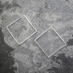 These Square Sterling Silver Minimalist Ear Cuffs are a modern on-trend innovative design ingeniously blending earring and ear cuff to give you a geometric designer look without the pain of multiple piercings! Up your ear game and mix and match different shapes for a really edgy style statement, or wear a pair as conventional drop earrings for a more classic approach to the design. Available singularly or as a pair, and in a variety of finishes. These versatile pieces also look wonderful worn in cartilage piercings! Made from: Sterling silver. Measurements: Earring Dimensions: approx. H3.0cm x W3.0cm Modern Metal Ear Cuff For Gifts, Modern Metal Ear Cuff For Gift, Modern Metal Ear Cuff As Gift, Modern Adjustable Ear Cuff As Gift, Modern Single Ear Cuff As Gift, Minimalist Metal Hoop Wrap Earrings, Modern Cartilage Earrings With Ear Wire As Gift, Modern Nickel-free Ear Cuff As Gift, Modern Square Nickel-free Earrings