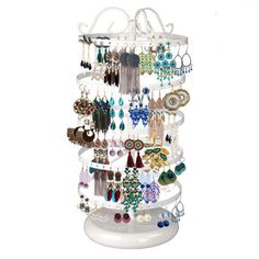 a white jewelry rack with lots of earrings on it