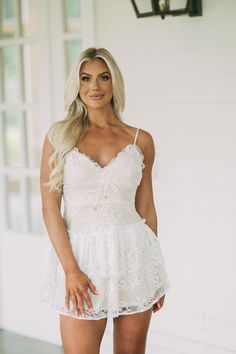 This beautiful white lace mini dress is the perfect piece for a special occasion. The delicate design features adjustable spaghetti straps, a neckline tie detail, a ruffled bottom hem, and a secure zipper closure in the back. The nude lining provides an elegant contrast and subtle coverage!   70% nylon, 30% polyester, lined  Model is 5'5" with a 35" bust, 26" waist, and 37" hips and wearing a small.  Size recs: 0-2-S, 4-6-M, 6-8-L  size up if between sizes  runs short! White Lace Mini Dress, Delicate Design, Lace Mini Dress, Petite Dresses, Trending Now, White Lace, Design Features, Spaghetti Strap, Special Occasion