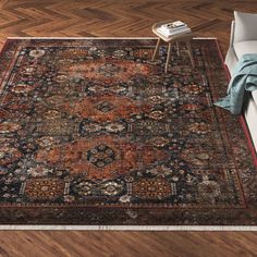 a large rug with an ornate design on the top and bottom, in a living room