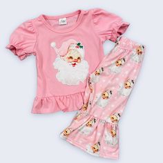 2pc Boutique Christmas Outfit Features Embroidered Santa On Short Sleeve Pink Top And Pink Santa Print Bell Style Pants. Christmas Cotton Sets For Festive Occasion, Cotton Festive Holiday Sets, Playful Cotton Sets For Holiday, Cute Cotton Holiday Sets, Cute Cotton Sets For Holidays, Cute Festive Winter Sets, Cute Fitted Holiday Sets, Cute Fitted Sets For Holiday, Playful Pink Sets For Holiday