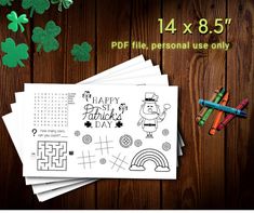 four st patrick's day coloring pages with markers and crayons next to them