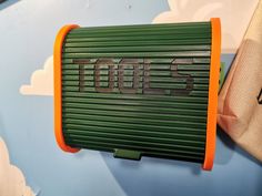 an orange and green speaker with the word boss on it