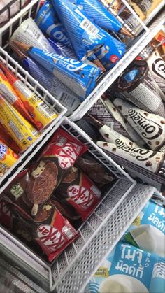 an open refrigerator filled with lots of different types of food and snacks in it's bins