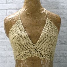 a mannequin wearing a crocheted halter top