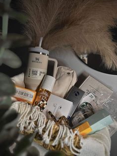 an assortment of items are sitting on a table next to a mirror and feather fan