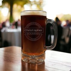 a beer mug sitting on top of a wooden table