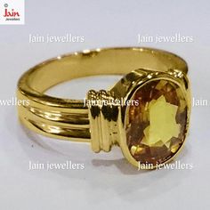 a gold ring with an oval cut stone in the center and four smaller bands around it