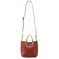 For a bag you can rely on, look to our Outwest Mini Tote. Handcrafted in soft genuine leather featuring, dual top handles, an adjustable shoulder strap, this bag combines practical features with our signature, expert craftsmanship. And, of course, its finished with our branded leather pullers and detachable main compartment charm. PRODUCT FEATURES 100% Genuine Leather 100% Vegetable Base Dyes 100% Recycled Hardware 100% Cotton Canvas Lining 100% Handcrafted Dual Top Handles Zipper Closure Exteri Cognac Leather Shoulder Bag With Handle Drop, Brown Hobo Bag With Top Carry Handle For On-the-go, Leather Handheld Shoulder Bag With Handle Drop, Handheld Leather Bag With Top Carry Handle, Handheld Leather Shoulder Bag With Handle Drop, Leather Handheld Bucket Bag For Shopping, Handheld Leather Bucket Bag For Shopping, Leather Handheld Hobo Bag With Top Carry Handle, Brown Satchel With Double Handle