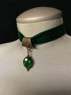 Green Velvet Choker! "Add a touch of elegance to your look with this **green velvet choker featuring a stunning **emerald green crystal** at its center. Perfect for the festive season, this **Christmas choker** makes a beautiful statement as **Christmas jewelry** or as a sophisticated **bridal accessory**. The choker is **adjustable** for a comfortable fit, making it an ideal piece for both **bridal jewelry** and holiday celebrations. Crafted with luxurious velvet, this choker exudes timeless charm and style for any occasion." This description highlights the versatility and elegance of the choker for both festive and bridal wear.... *This very elegant "green velvet choker" measures 12" in length....the crystal measures 3/4" in height, and 1/2" in width....if you would prefer to have this c Adjustable Victorian Choker For Formal Occasions, Victorian Adjustable Choker For Formal Occasions, Victorian Style Adjustable Choker For Formal Occasions, Elegant Adjustable Green Choker, Elegant Green Adjustable Choker, Formal Jeweled Choker, Vintage Jeweled Choker For Parties, Elegant Adjustable Choker For Festive Occasions, Elegant Adjustable Festive Choker