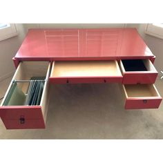 a pink desk with drawers underneath it