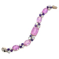 This amazing bracelet is set with the main center 24 carat natural Kunzite (20mm x 15mm) enhanced with brilliant white diamond cut natural Topaz and little natural glittering Amethysts. Set in this beautiful Sterling Silver bracelet it is 7 inches long and fits snugly and comfortably on your wrist. We have included a pair of matching earrings for free as a gift to the buyer because the earrings are not perfectly matched when sitting next to each other but look wonderful when on your ears. If you Modern Bracelets, Free Earrings, Diamond Cut, Bracelet Designs, Matching Earrings, White Diamond, Sterling Silver Bracelets, Pandora Charm Bracelet, Topaz