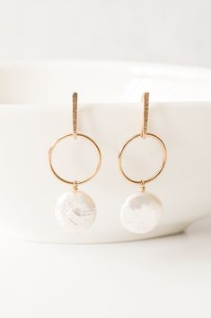 "Not your mama's pearls earrings! A fresh take on a classic design. These freshwater coin pearls are modern but with edgy femininity.  14kt gold fill. Earrings measure: 1 3/4\"L x 1/2\"W Mindfully designed and handmade in Houston, TX." Pearl White Round Earrings For Everyday, Modern Pearl Earrings For Anniversary, Minimalist Round Pearl Drop Earrings, Modern Round Pearl Earrings With Pearl Charm, Minimalist Pearl Pendant Earrings For Anniversary, Everyday Pearl Pendant Earrings, Modern White Earrings With Pearl Charm, Everyday Pearl Earrings With Pearl Charm, Everyday Pearl Charm Earrings