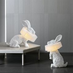 two white rabbit lamps sitting on top of a table