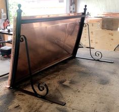 a large metal frame sitting on top of a wooden floor