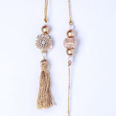 Express your love with this premium gold work bhaiya bhabhi rakhi set. A stunning set, it comprises of artistically designed rakhis with a gold-work pendant at the center. Gold and white beads adorn the 1-inch pendant on two sides, while a gold latkan adds to the beauty of the rakhi for bhabhi. Order this designer set today. Rakhi For Bhabhi, Gold Work, White Beads, Cotton Thread, Gold Material, Tassel Necklace, 1 Inch, Beads, Pendant