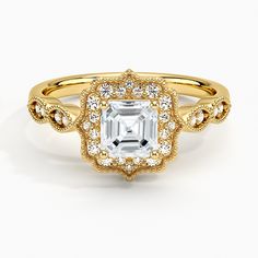 a gold engagement ring with an emerald center surrounded by diamonds