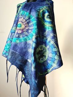 Large blue felted scarf made of natural materials. This is an author's scarf for lovers of unique things and clothes. The scarf is made of delicate merino wool and natural silk, which is hand-painted. Mandalas are painted on the scarf, which mystically attract our attention. Such a scarf can be worn in any season and with any clothes, it can be jeans and a jacket or an evening dress. The size of the scarf is 204 cm / 80 inches long and 61 cm / 24 inches wide. The scarf can be washed gently by ha Handmade Blue Scarves As Gifts, Handmade Blue Scarf As A Gift, Artsy Blue Scarf As Gift, Artsy Blue Scarf As A Gift, Artsy Blue Scarf Perfect As A Gift, Blue Shawl Scarf For Gift, Artsy Blue Scarves As Gifts, Artsy Blue Scarf For Gift, Handmade Blue Shawl For Winter